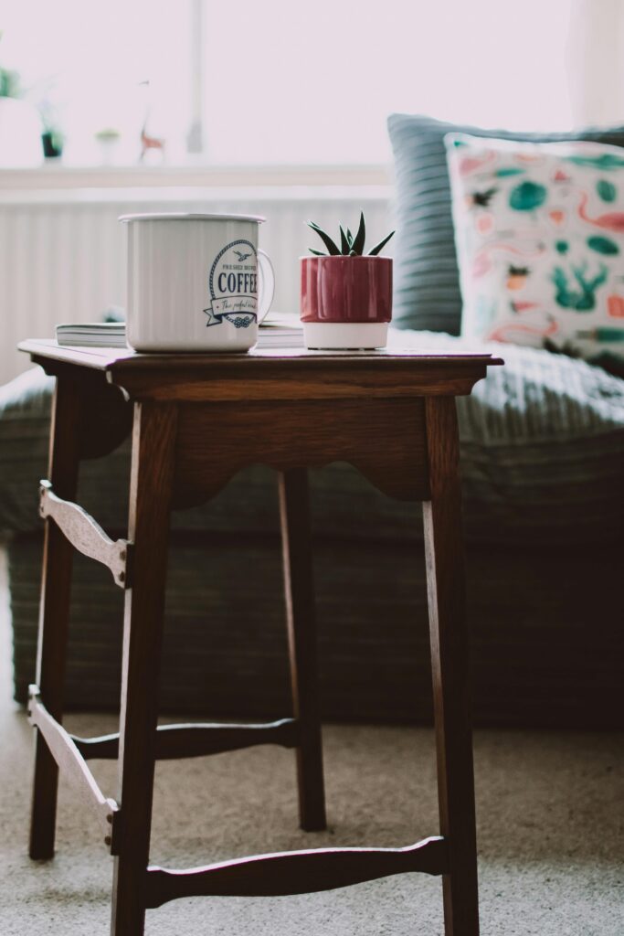 Inviting living room setup featuring a coffee cup, plant, and wooden table.